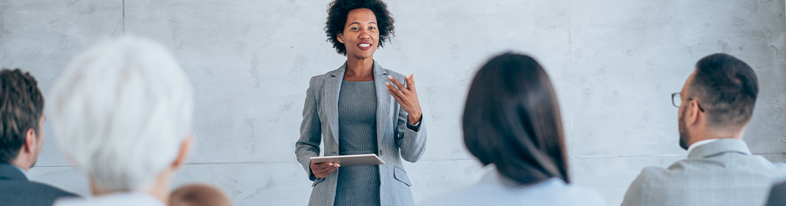 Instructor teaching project management course to group of professionals